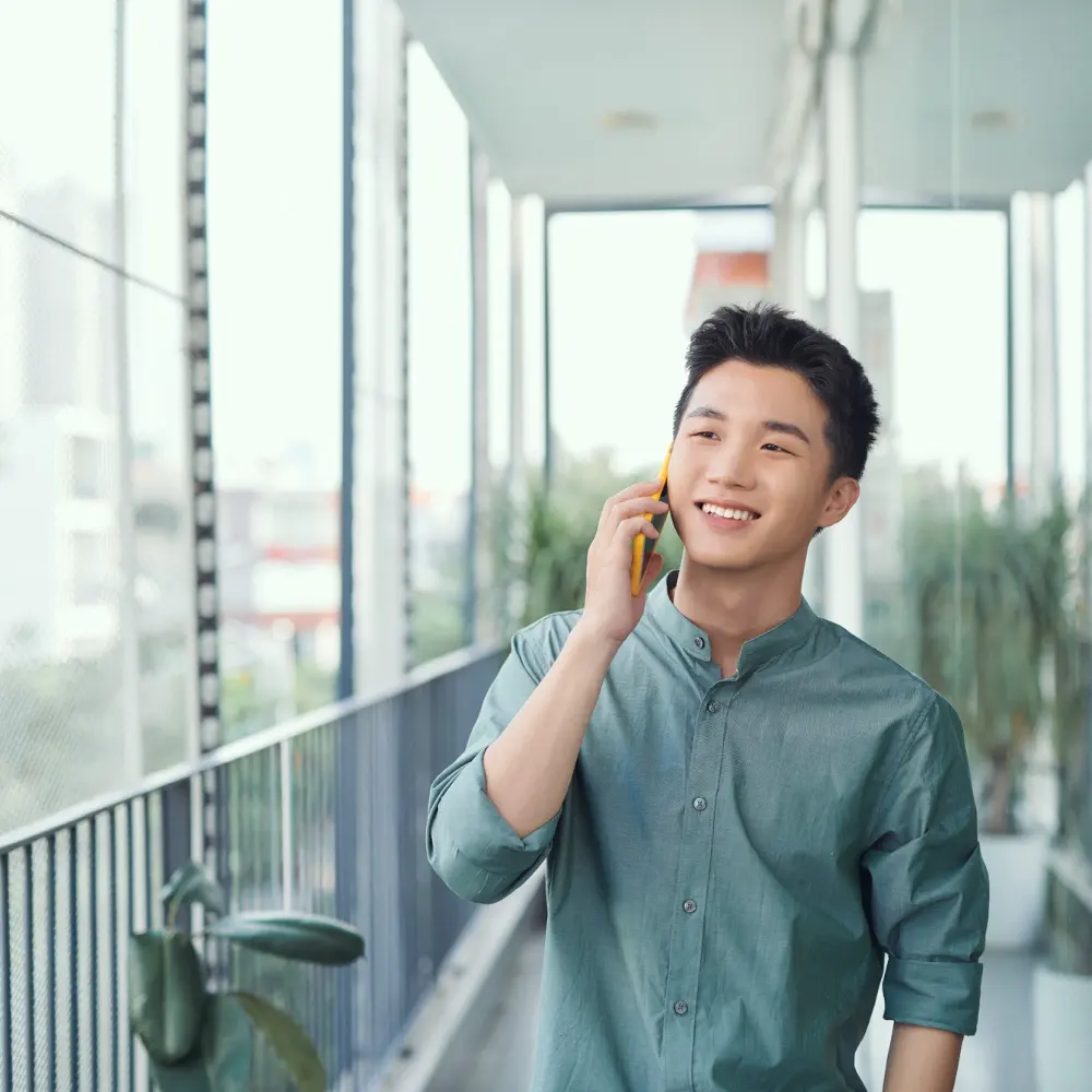 Man on a phone call representing AI voice agent handling customer interactions at scale