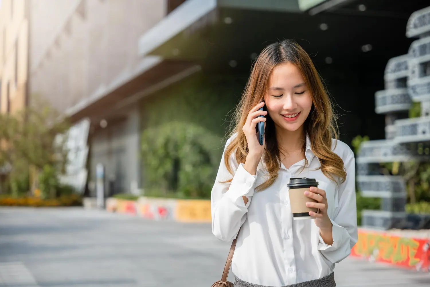business-testing-ai-voice-agents-prototype Business professional testing an AI voice agent prototype during a customer phone conversation.