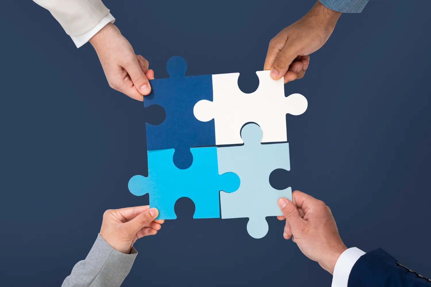 custom-ai-voice-agents-proof-of-concept Hands assembling puzzle pieces to represent building a custom AI voice agent prototype for a business.