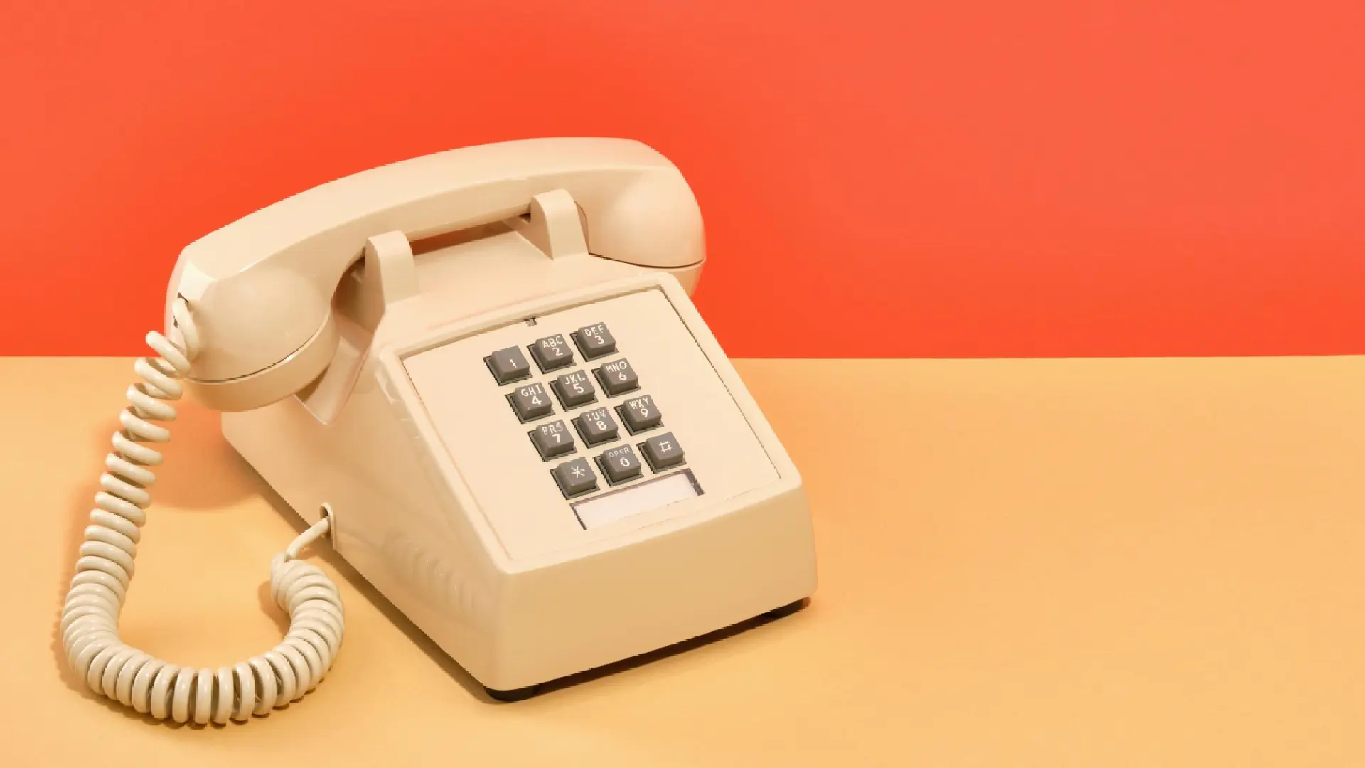 Vintage corded phone and desk calculator representing the outdated IVR system many Singapore businesses have outgrown